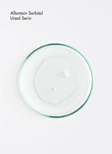 Clear gel in a petri dish labeled Allantoin Sorbitol Ureal Serin, showcasing a skincare ingredient.