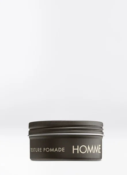 Homme Texture Pomade in sleek aluminum pot, modern styling product for effortless, casual hairstyles.