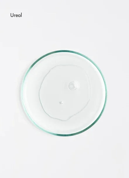 Clear gel in a petri dish showcasing the texture of the nourishing foot cream for dry skin.