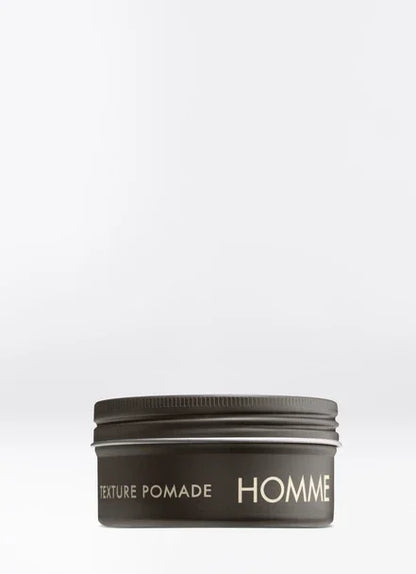 Homme Texture Pomade in sleek aluminum pot, modern styling product for effortless, casual hairstyles.